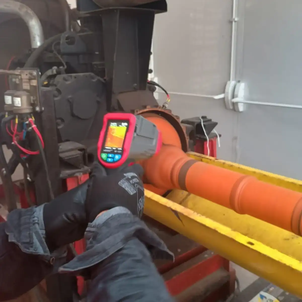 Técnico medindo temperatura do eixo da bomba de incêndio com câmera termográfica portátil